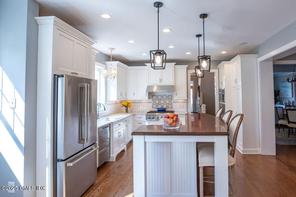 9 Center Road Old Greenwich, CT 06870 - Photo 6 of 26 a kitchen with stainless steel appliances a refrigerator a sink and a stove