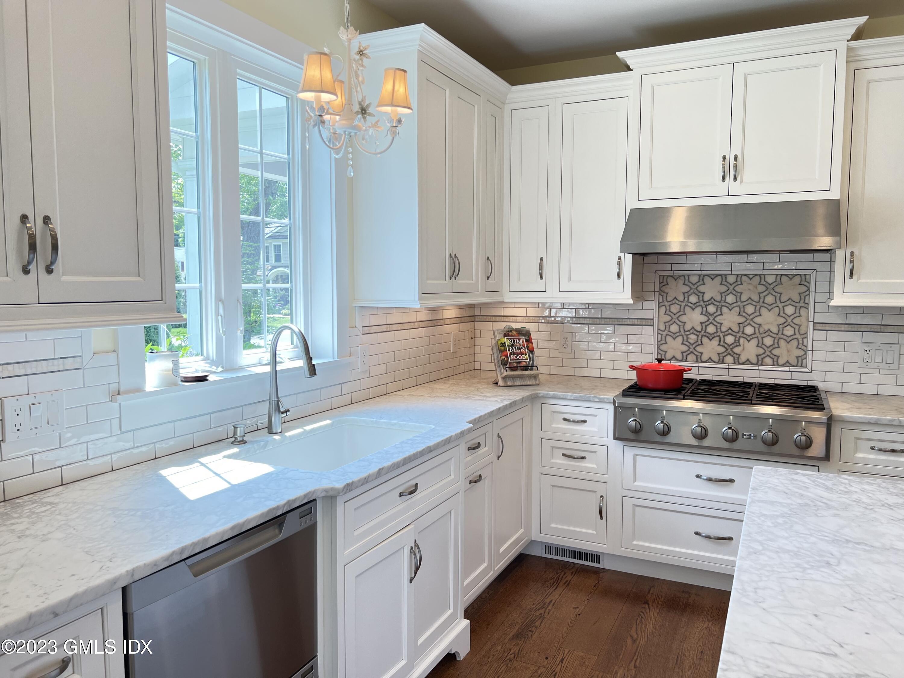 9 Center Road Old Greenwich, CT 06870 - Photo 7 of 26 a kitchen with kitchen island granite countertop a sink stainless steel appliances and cabinets