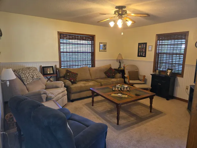 a living room with furniture a rug and a window