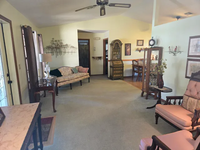 a living room with lots of furniture and a refrigerator