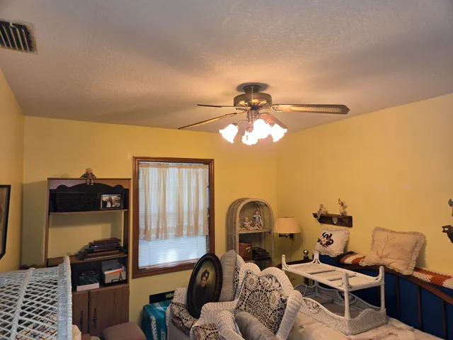 a living room with furniture a flat screen tv and a window