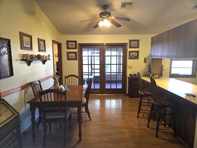a view of a a dining room with furniture window and wooden floor