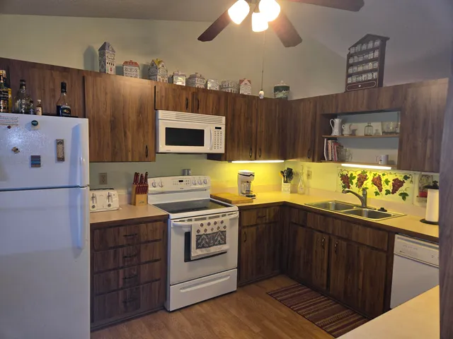 a kitchen with stainless steel appliances a stove a sink and a refrigerator