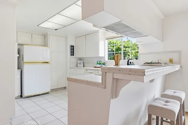 a kitchen with a sink cabinets and window