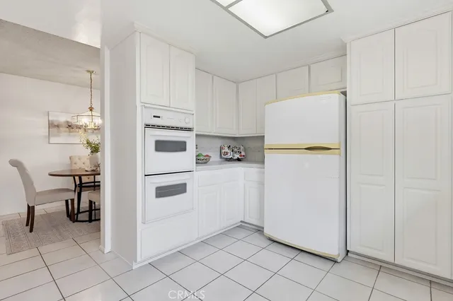 a kitchen with cabinets and refrigerator