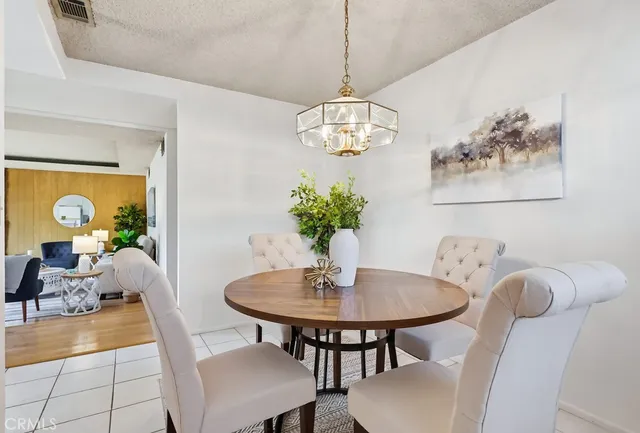 a view of a dining room with furniture wooden floor and a chandelier