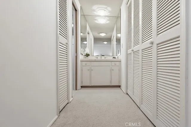 a bathroom with a granite countertop sink a toilet and a mirror