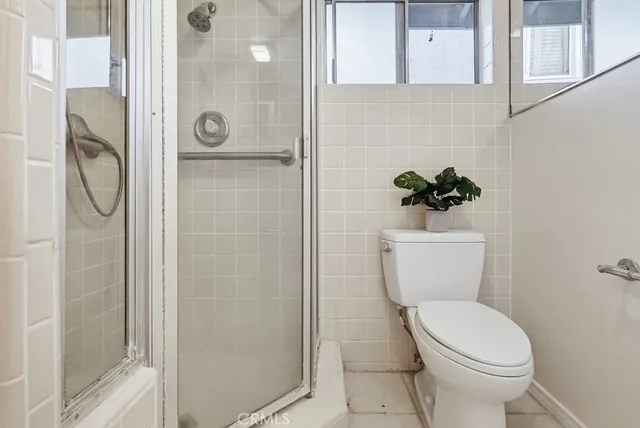a white toilet sitting next to a bathroom sink
