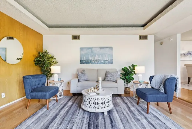 a living room with furniture and a potted plant