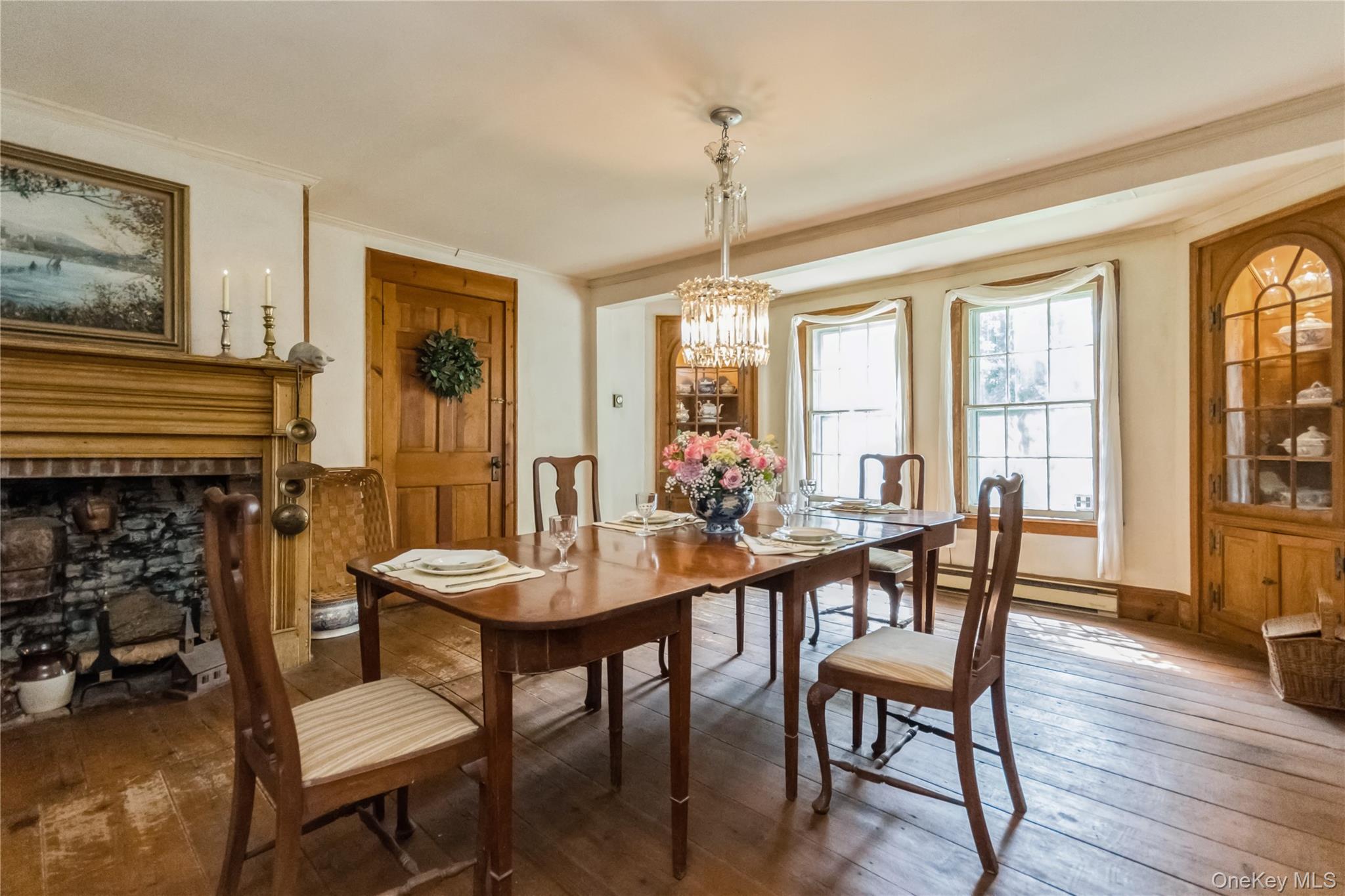 93 Widmer Road Wappingers Falls, NY 12590 - Photo 11 of 45 Dining room featuring ornamental molding, a chandelier, wide board flrs, a fireplace