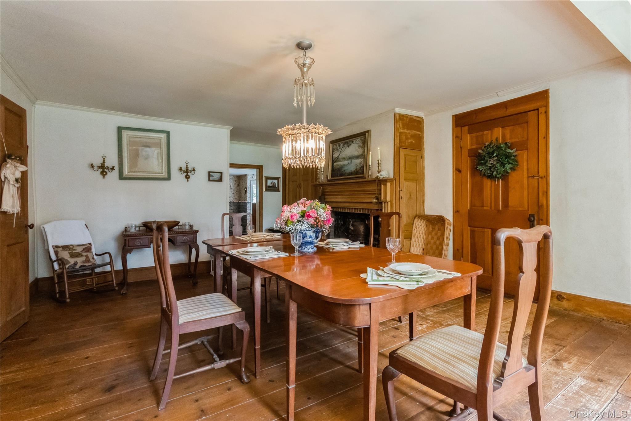 93 Widmer Road Wappingers Falls, NY 12590 - Photo 15 of 45 Dining area with fireplace, china cabinets, chandelier, wide board flrs.