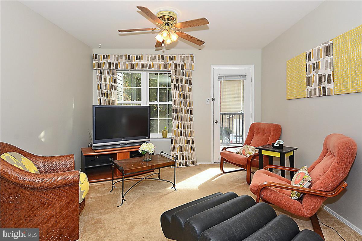 3305 Wyndham Circle, Unit 252 Alexandria, VA 22302 - Photo 15 of 20 a living room with furniture a air conditioner vent and a window