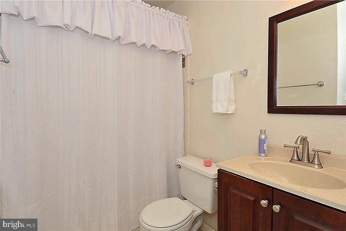 3305 Wyndham Circle, Unit 252 Alexandria, VA 22302 - Photo 10 of 20 a bathroom with a sink vanity mirror and toilet