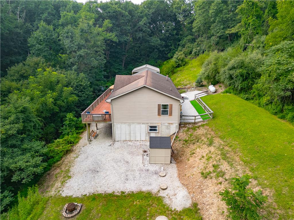 7353 Farrier Road Orefield, PA 18069 - Photo 55 of 74 Dense woodlands border this multi-level home featuring an expansive elevated deck and concrete foundation.
