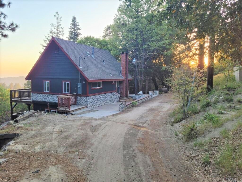 a view of a house with a yard and sitting area