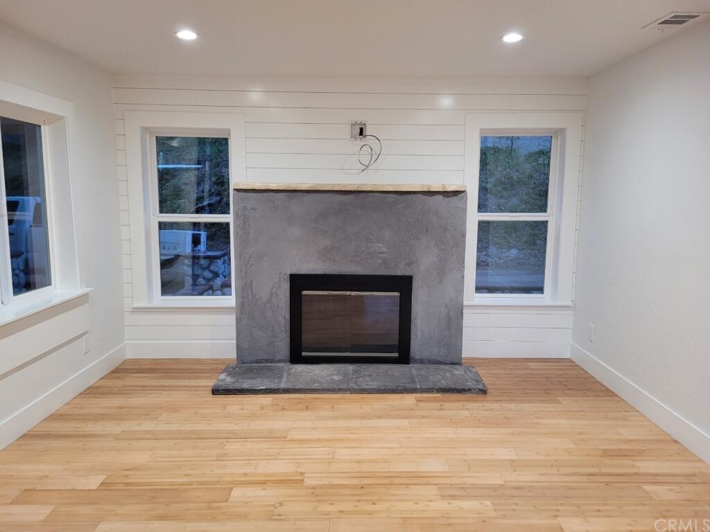 582 Sunset View Road Twin Peaks, CA 92391 - Photo 12 of 18 a living room with a fireplace and a wooden floor