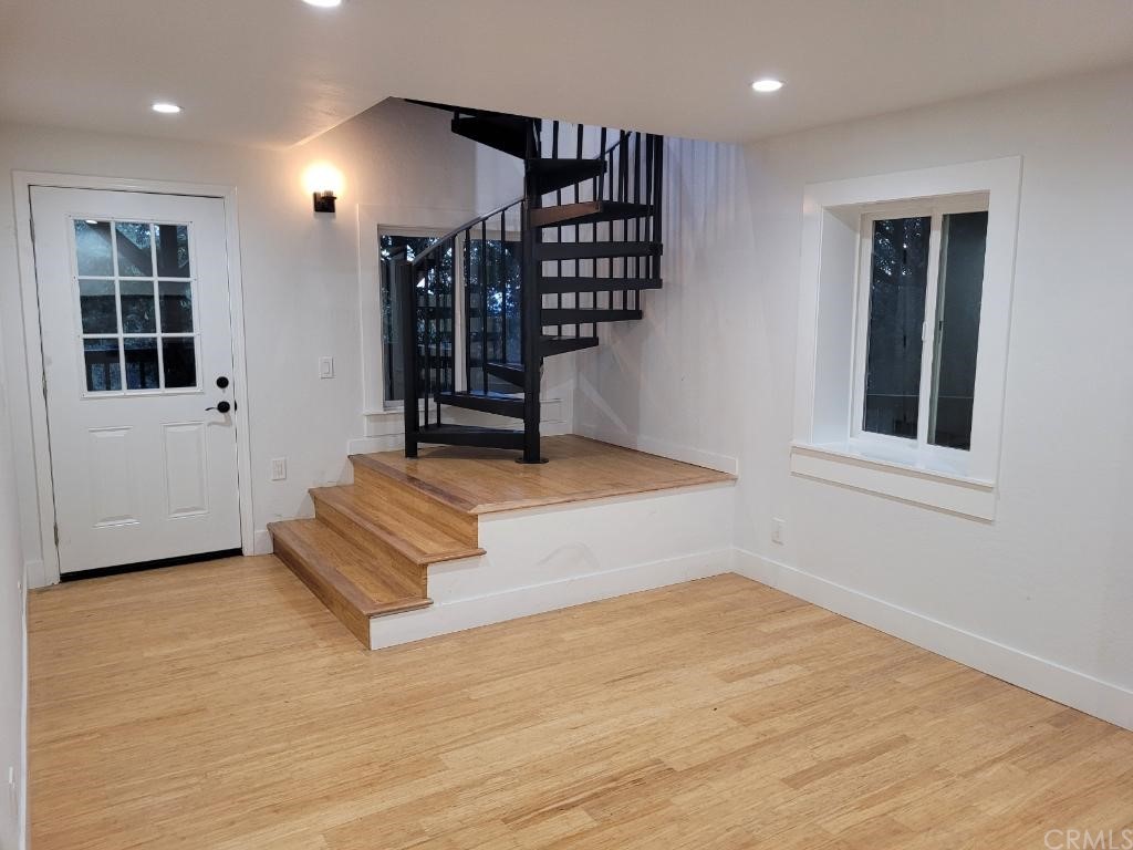 582 Sunset View Road Twin Peaks, CA 92391 - Photo 13 of 18 an empty room with windows and chandeliers