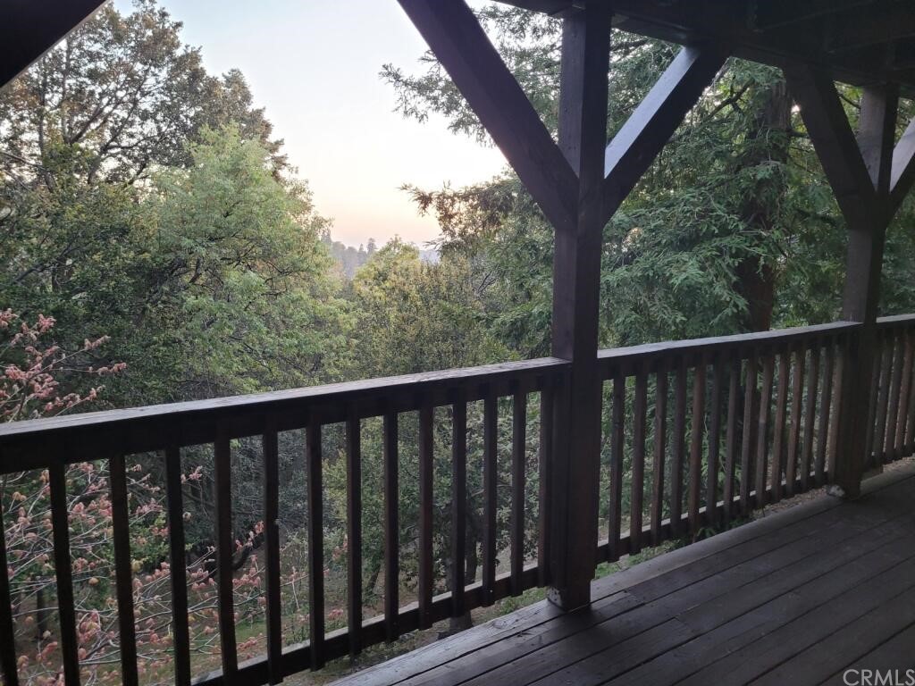 582 Sunset View Road Twin Peaks, CA 92391 - Photo 17 of 18 a view of a balcony with wooden fence and floor