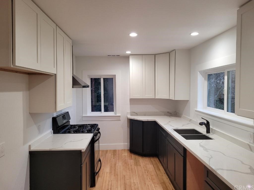 582 Sunset View Road Twin Peaks, CA 92391 - Photo 7 of 18 a kitchen with a sink dishwasher a stove and a refrigerator with wooden cabinets
