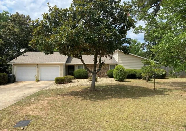 a house that has a tree in front of it