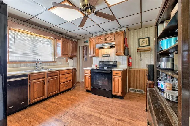 a kitchen with stainless steel appliances granite countertop a stove and a sink