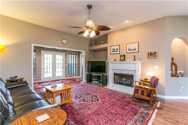 817 Oslo Road Mount Juliet, TN 37122 - Photo 4 of 17 a living room with furniture a flat screen tv and a fireplace