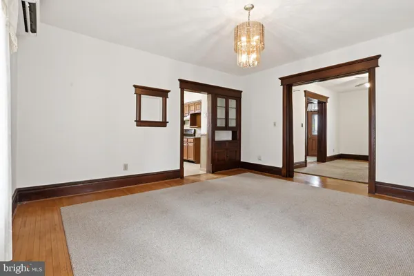 a view of a room with wooden floor and windows