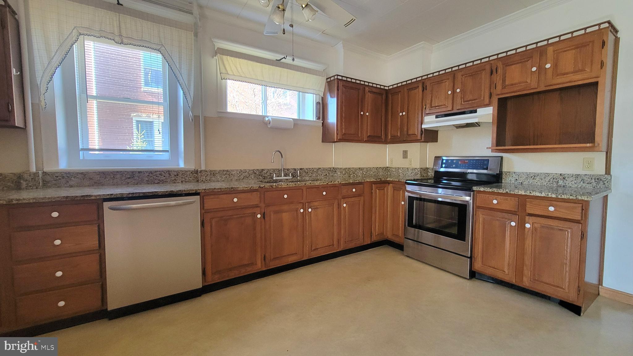 72 South Main Street Smithsburg, MD 21783 - Photo 15 of 48 a kitchen with stainless steel appliances granite countertop a stove sink and cabinets