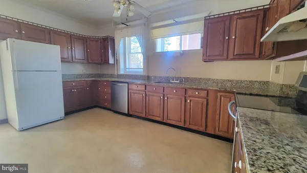 an empty room with wooden floor and a window