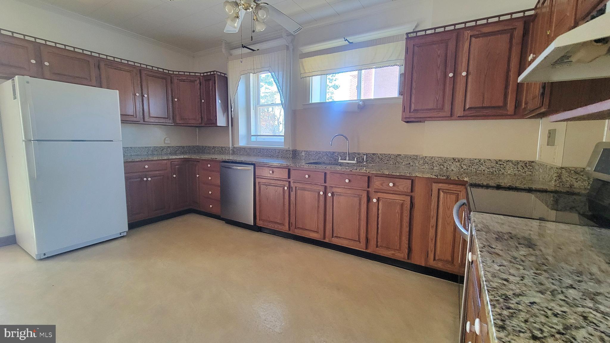 72 South Main Street Smithsburg, MD 21783 - Photo 16 of 48 a kitchen with stainless steel appliances granite countertop a refrigerator a sink dishwasher a stove with wooden cabinets and floor