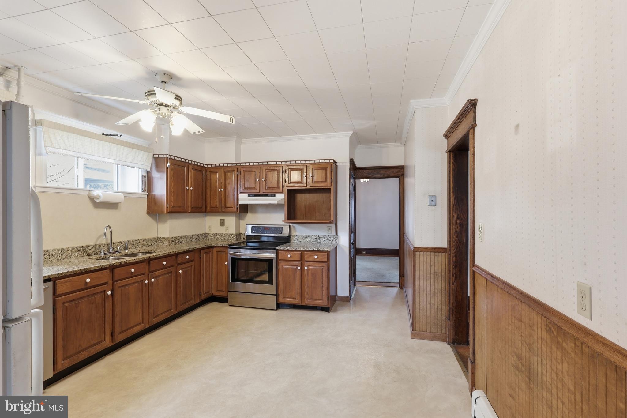 72 South Main Street Smithsburg, MD 21783 - Photo 17 of 48 a large kitchen with cabinets and stainless steel appliances