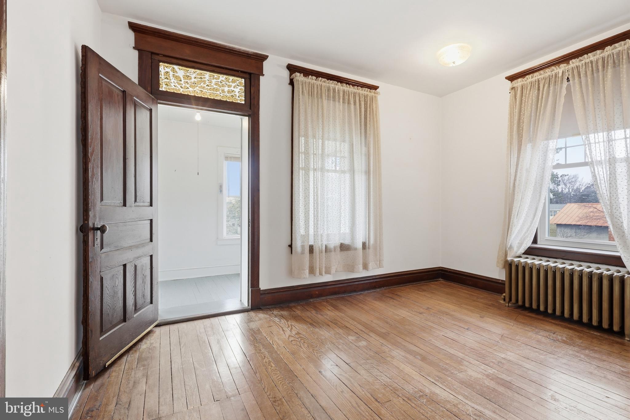 72 South Main Street Smithsburg, MD 21783 - Photo 29 of 48 an empty room with wooden floor and a window