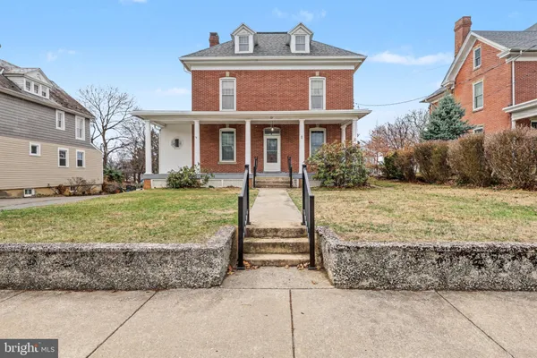 a front view of house with yard and outdoor seating