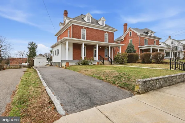 a view of a livingroom with a fireplace and stairs