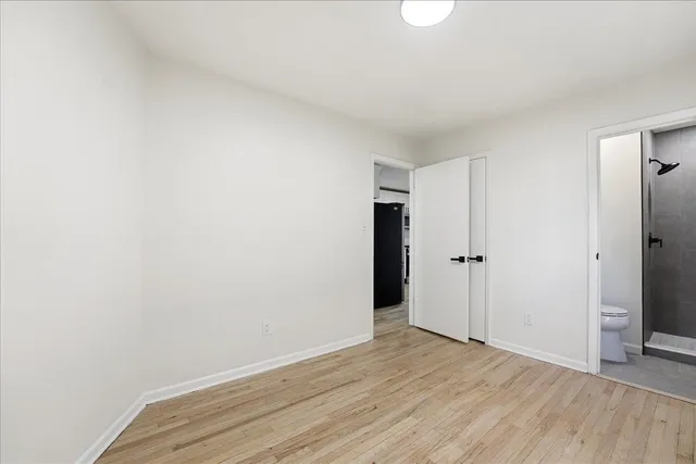 a view of an empty room and wooden floor