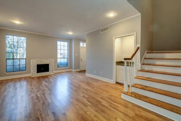 wooden floor in an empty room with a fireplace