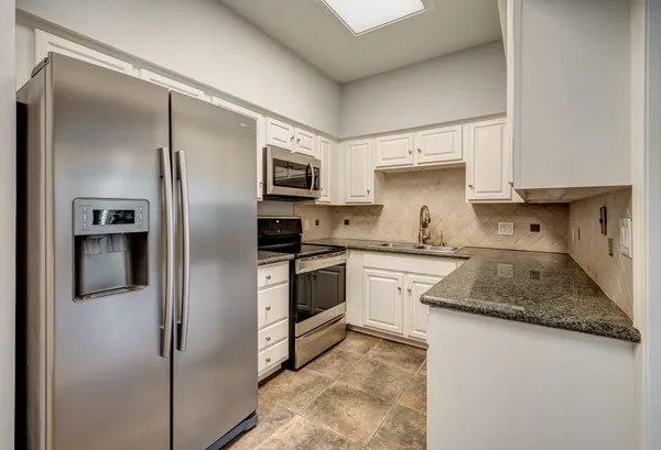 a kitchen with a refrigerator sink and stove