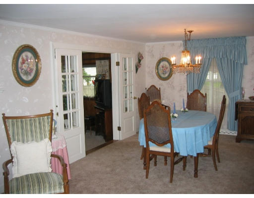 95 Winchester Road Arlington, MA 02474 - Photo 3 of 6 a dining room with furniture and a chandelier
