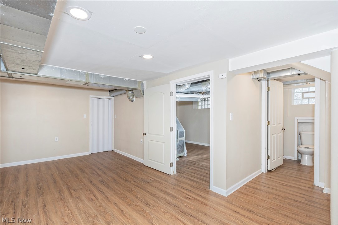 917 Brunswick Road Cleveland Heights, OH 44112 - Photo 35 of 42 Fresh finished, waterproofed basement with vinyl plank flooring and overhead light, complete with half bath and additional storage.