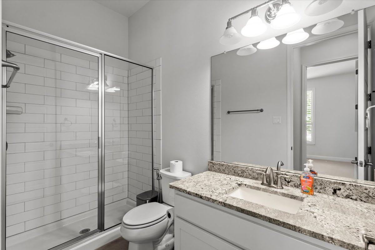4108 Bison Bend, Unit FOR RENT Cedar Park, TX 78613 - Photo 17 of 36 Full bathroom 2 on the main level. Refined bathroom features a glass-enclosed shower and a granite-topped vanity.