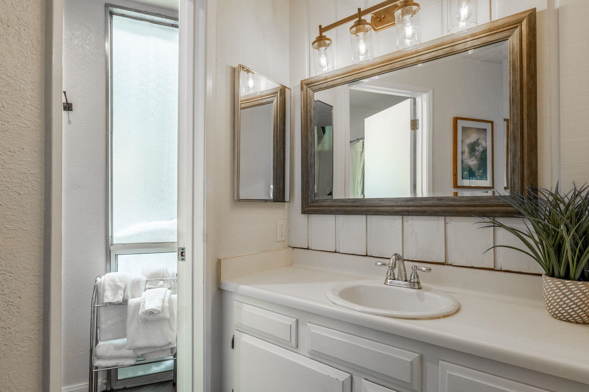 286 Old Mammoth Road, Unit 71 Mammoth Lakes, CA 93546 - Photo 21 of 24 Full bathroom with vanity, a textured wall, and curtained shower