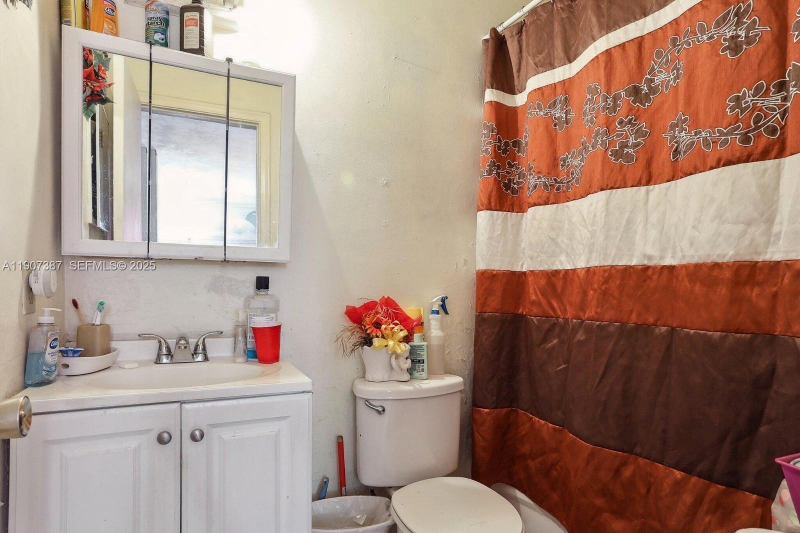 231 Southwest 8th Court Pompano Beach, FL 33060 - Photo 14 of 21 a bathroom with a sink toilet and vanity