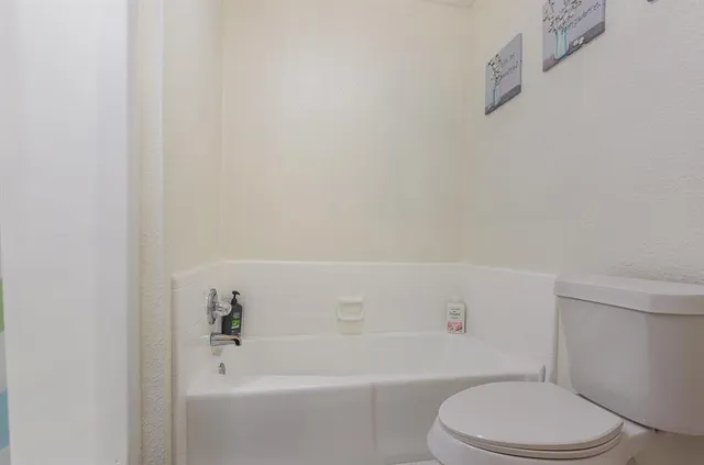 a white toilet and a bath tub