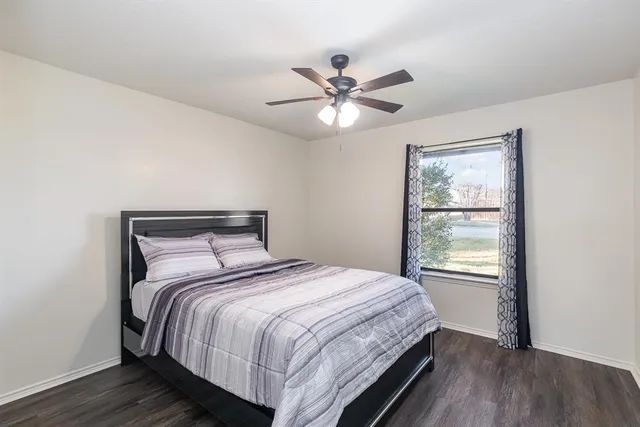 a bedroom with a large bed and a window