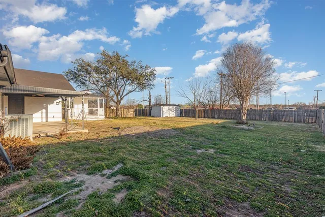 a view of yard with swimming pool and green space