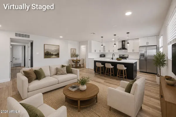 a living room with furniture kitchen view and a table