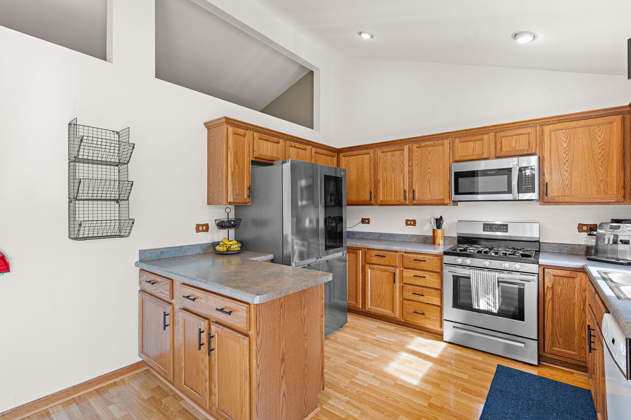 8987 Calhoun Place Crown Point, IN 46307 - Photo 9 of 28 a kitchen with stainless steel appliances granite countertop a sink stove and refrigerator