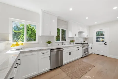 a kitchen with a sink and white cabinets