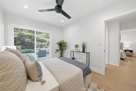 a bedroom with a bed and a large window
