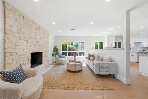 a living room with furniture fireplace and window